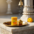 Jar on a marble surface with incense and flowers, traditional setting.