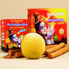 Kashi Tulsi Ashtagandha Chandan Tika with a yellow ball and sticks on a beige background