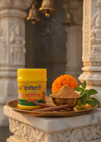 Jar of Bhringraj with a bowl of powder on a decorative platform with religious architecture in the background.