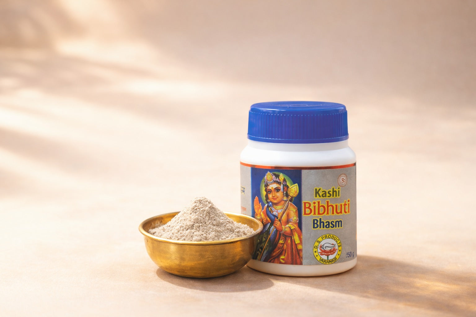 Kashi Bibhuti Bhasma container with a bowl of powder on a beige background