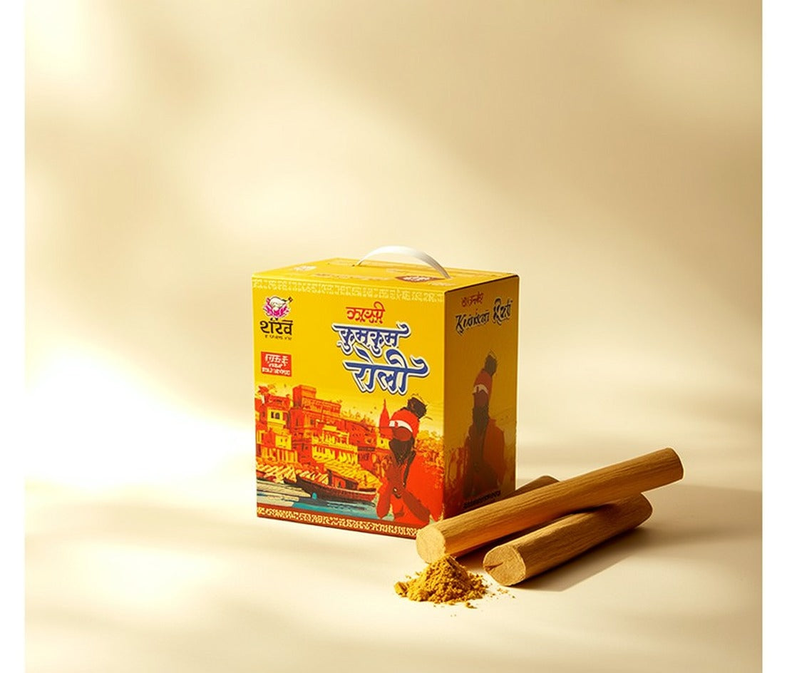Yellow box with traditional design and two sticks on a beige background