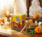 Box of 'Bhagwan' brand product on a decorative table with flowers and a candle.