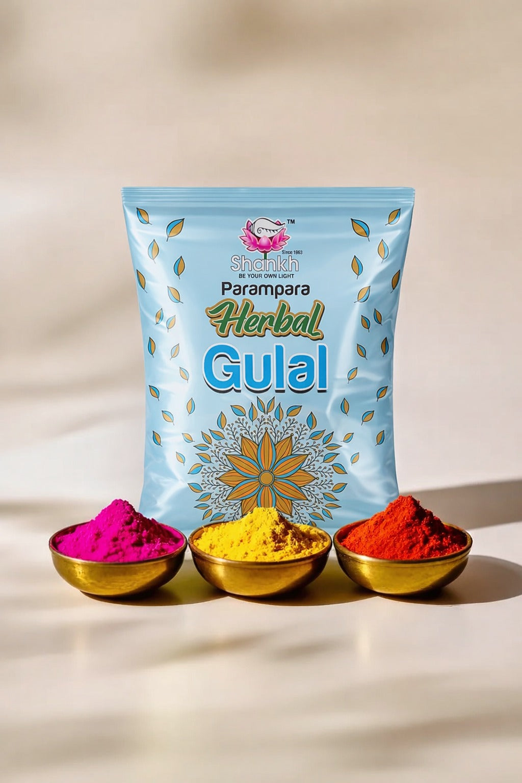 Packaging of Parampara Herbal Gulal with three small bowls containing colorful gulal powder on a beige background.