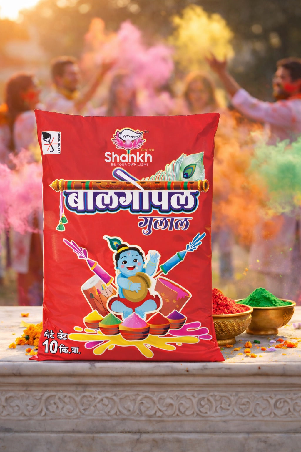 Red packet of Shahkh holi colors with people celebrating Holi in the background