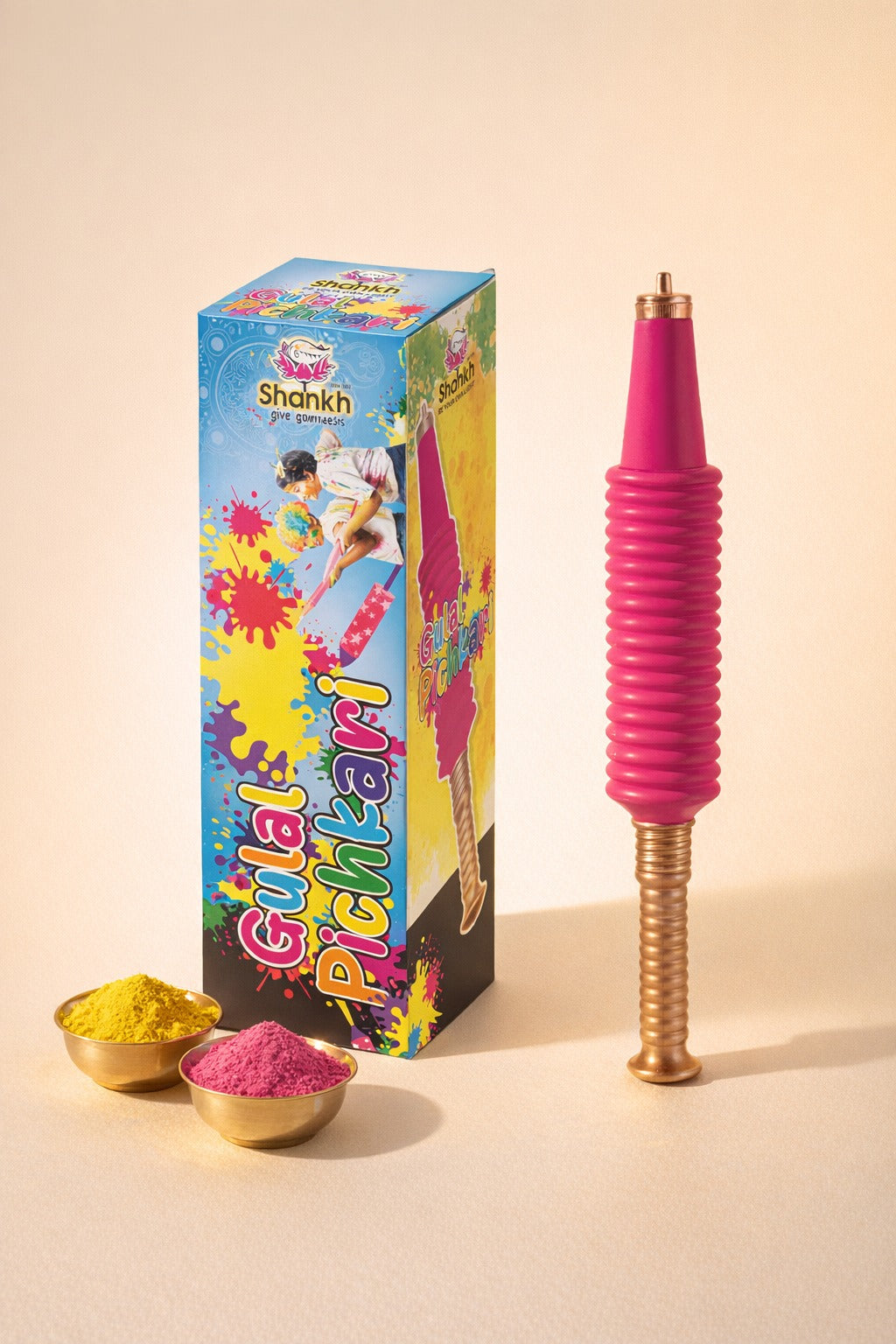 Colorful Holi powder with a pink and gold stick and packaging on a beige background