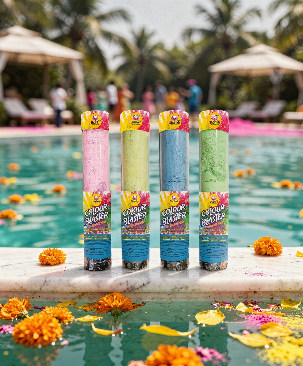 Four Color Blaster cans by Raja's on a poolside ledge with flowers and people in the background.