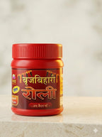 Red and gold jar with text on a beige background