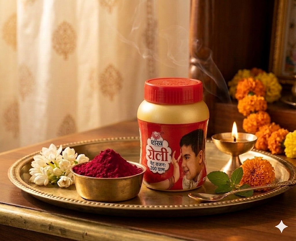Jar of colored powder with a red lid on a tray with flowers and a candle, against a curtain background.