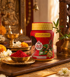 Red container with gold lid on a wooden surface with decorative elements