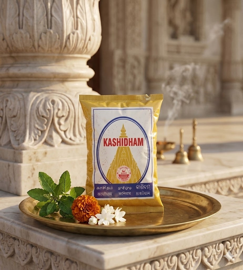 Kashidham package on a decorative tray with flowers and leaves in front of a temple.