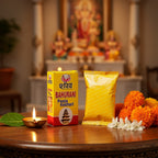 Bhagwan Bahurani Puja Keshari packaging on a table with flowers and a lit lamp, blurred background of神灵.