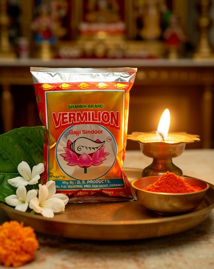 Vermilion powder packaging with a lit lamp and flowers on a wooden tray