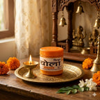 Jar of Chhola on a wooden table with marigold flowers and a lit candle