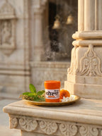 Candle and flowers on a decorative stone platform with architectural background