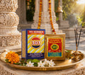 303 Number Vermillion packaging on a decorative tray with flowers and incense in front of an architectural background.