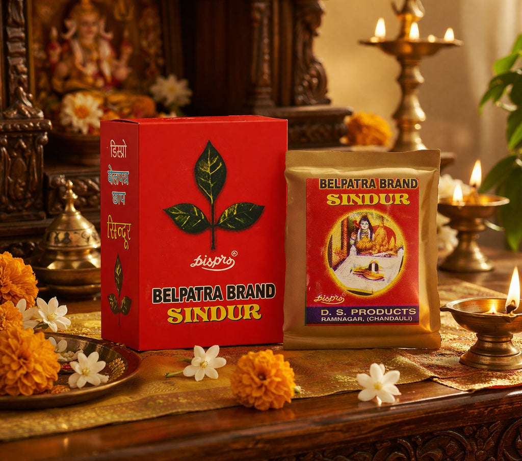 Belpatra Brand Sindur packaging on a decorative table with flowers and candles.