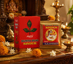 Belpatra Brand Sindur packaging on a decorative table with flowers and candles.