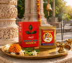 Belpatra Brand Sindur packaging on a tray with flowers and incense in front of a temple.