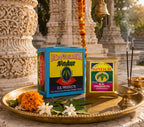 Sindur boxes on a tray with flowers and incense in front of temple architecture