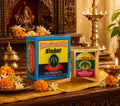 Two boxes of D.S. Products Sindur on a decorative table with flowers and candles.