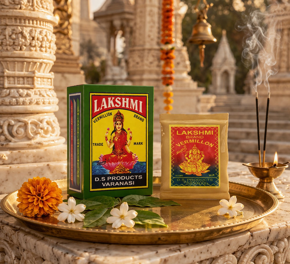 Lakshmi vermillion packaging on a decorative tray with flowers and incense in front of temple architecture.