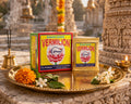 Shankh Brand vermiculite packaging on a decorative tray with flowers in front of temple architecture.