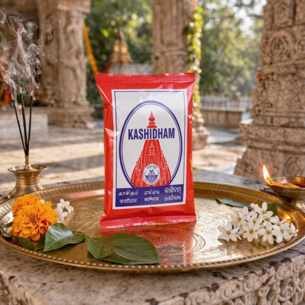 Kashidham package on a decorative tray with flowers and temple background