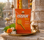 Orange packet with text on a decorative platform in front of temple architecture