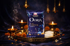 Shankh Oorja Pure Camphor Tablet packaging on a dark background with candles and flowers.