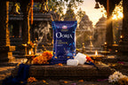 Orja Camphor Tablet packaging with incense and flowers on a traditional setting