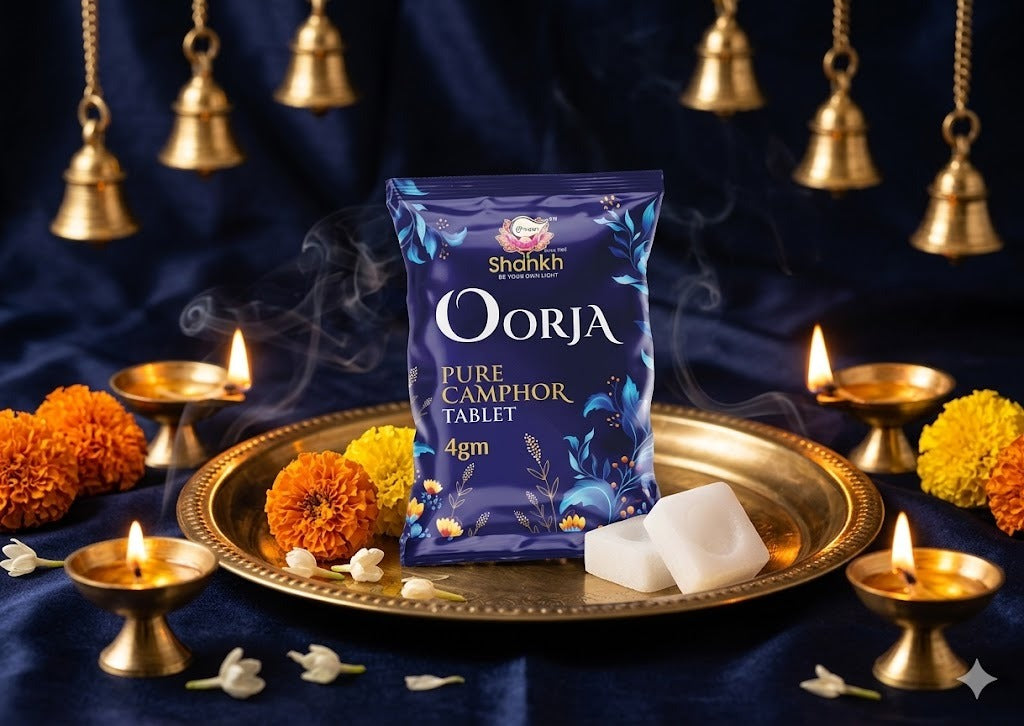 Shankh Oorja pure camphor tablet packaging on a decorative tray with candles and flowers against a dark background.