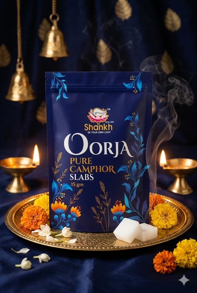 Shahnaz Oorja Pure Camphor Slabs packaging on a decorative tray with flowers and candles.
