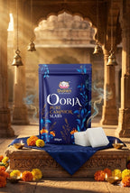 Shankh Oorja Pure Camphor Slabs packaging in a traditional setting with flowers and candles.