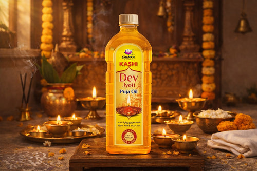 Kashi Dev Jyoti Puja Oil bottle on a wooden platform with a temple setting in the background