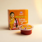 Shahnkh Mahalaxmi Suhag Sindoor packaging with a woman's face on an orange background