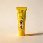 Yellow tube of Kashi Chandan Tikka on a beige background