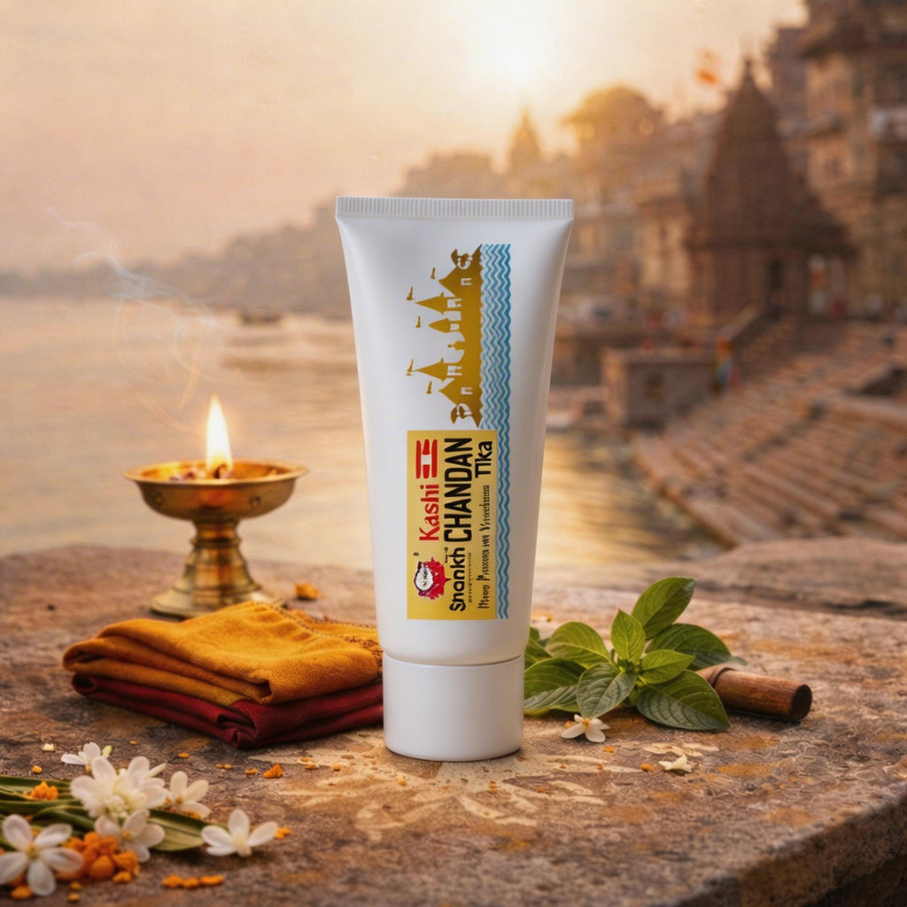 Tube of Kashi Chandan Tika with traditional elements on a stone surface with a scenic background
