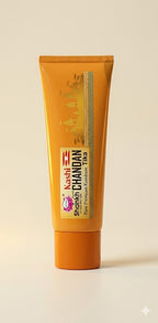 Keshi Parichay Chandan Tika tube on a beige background