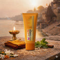 Kashi Chandan shampoo tube with traditional elements on a stone surface with a scenic background