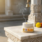 Incense stick holder with smoke on a decorative table in a temple setting