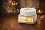 Jar of cream with a decorative background featuring candles and flowers