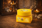 Yellow jar with a lid on a wooden surface with decorative elements