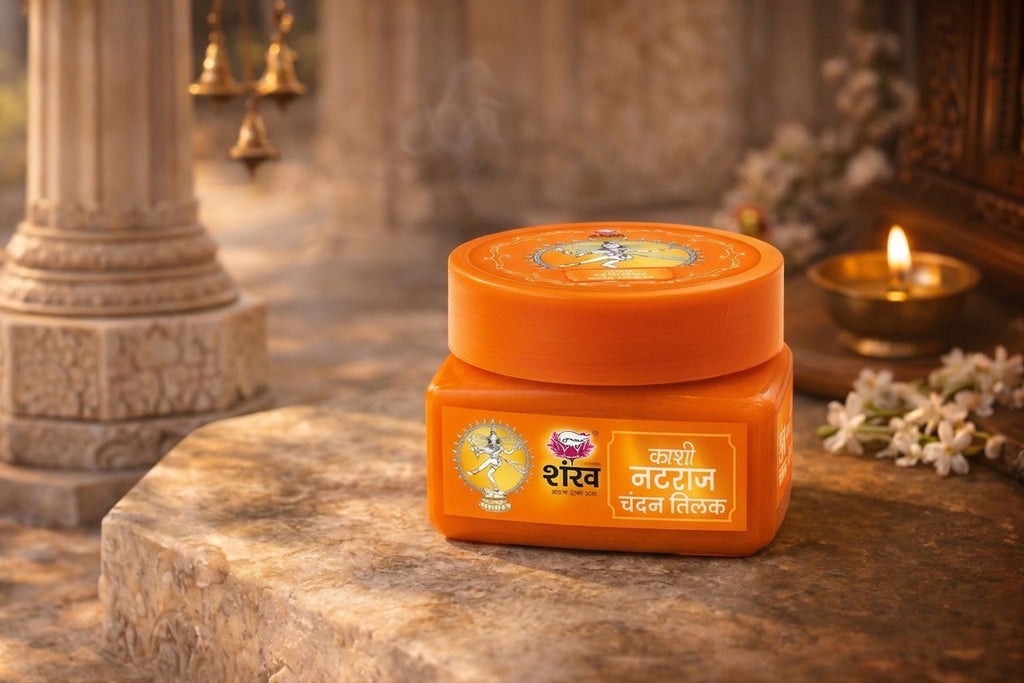 Orange jar with a decorative label on a stone surface with floral and architectural elements in the background.